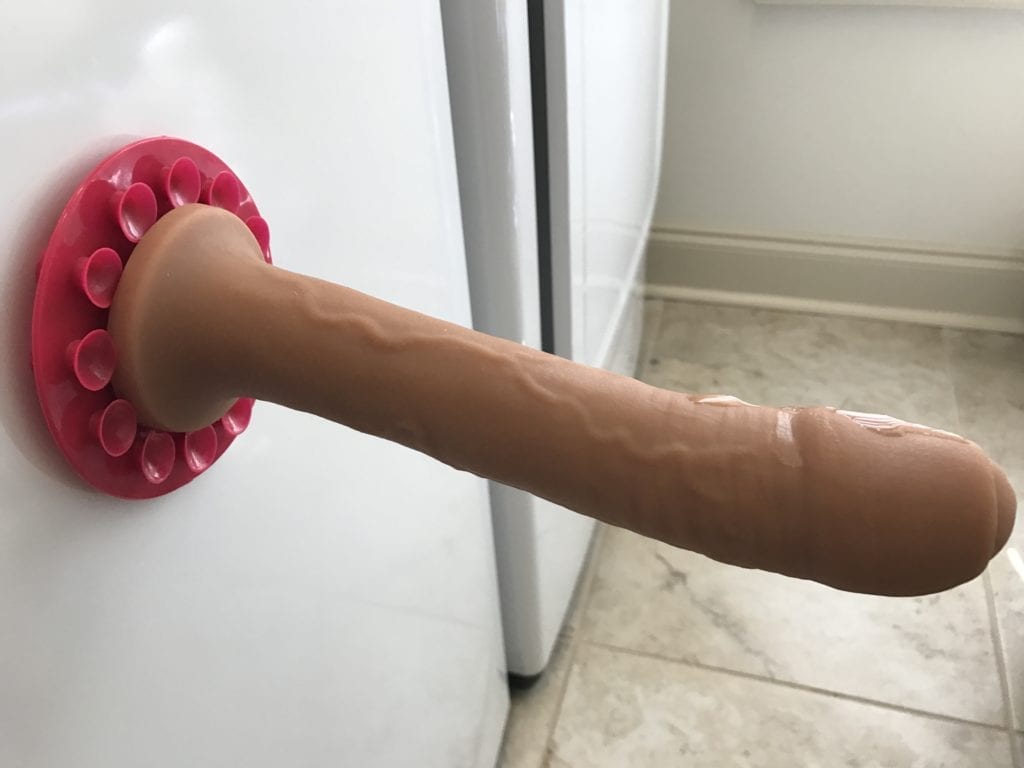 girl using suction cup dildo