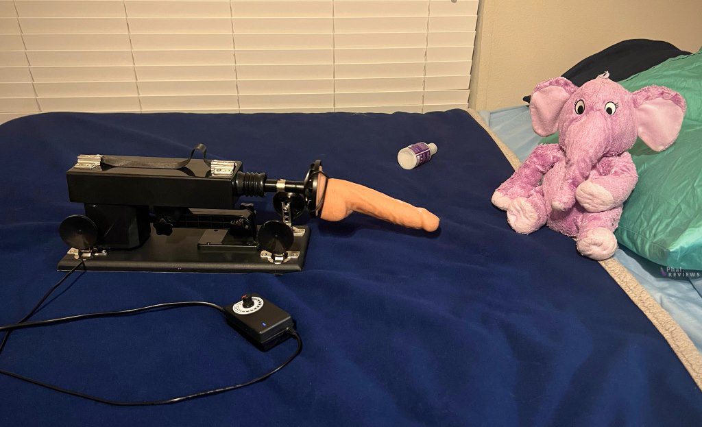 Hismith basic thrusting machine dildo gun with suction cup attachment on bed