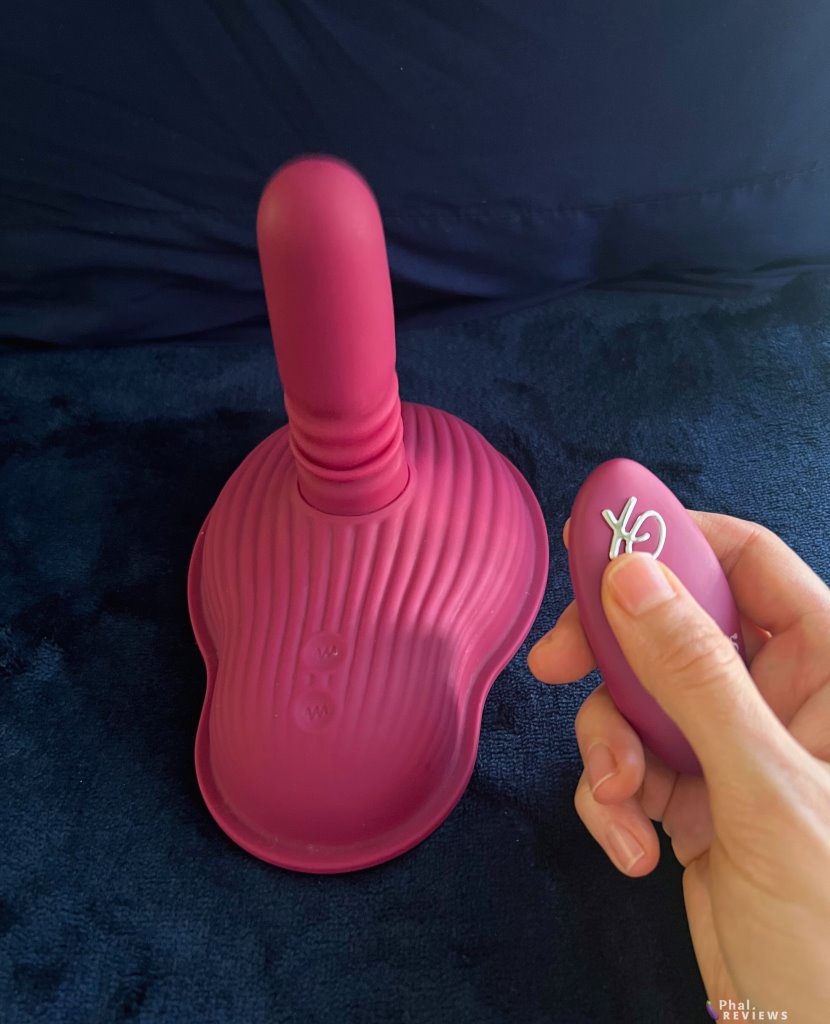 Thrust & Grind thrusting vibrator with remote control in hand