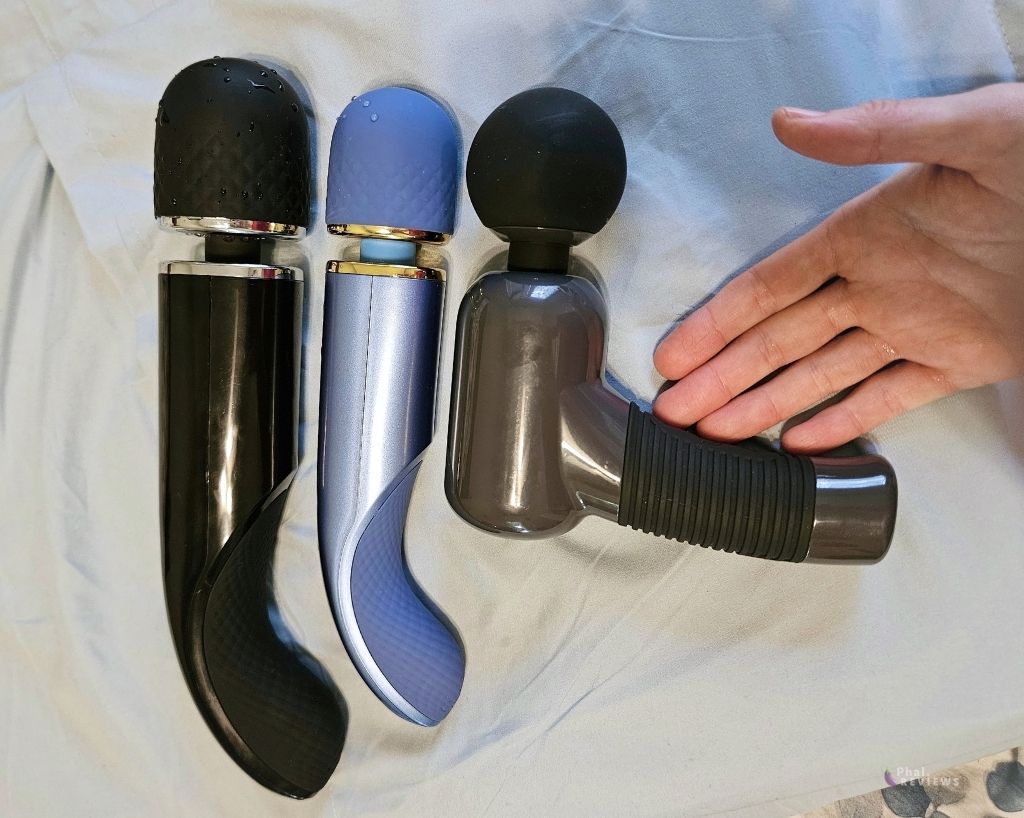 3 Pretty Love products size compared size vs. hand: black Super Power wand large vs. blue Super Power wand medium vs. black Massage Gun vs. reviewer's palm and fingers, over light blue pillowcase