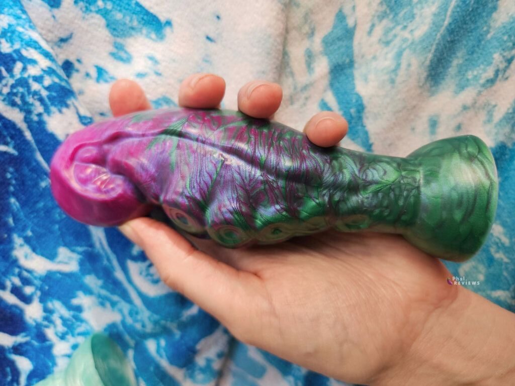 Custom magenta to forest green pearlescent pigments are swirled during pouring by Uberrime dildos, creating a "feathered" silicone effect. silicone in size large Haliae tentacle plug by Uberrime toys