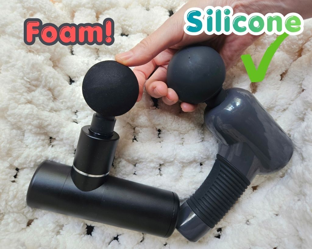 Foam massage gun head vs. silicone Massage Gun heads resting over cream crocheted blanket to show material texture differences