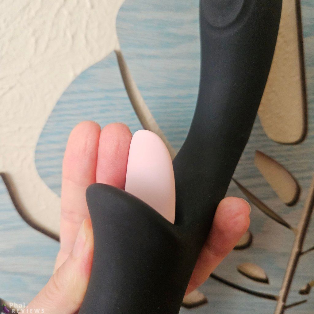 Closeup of first 2 fingers next to the rounded silicone tongue on the Glossa vibrator